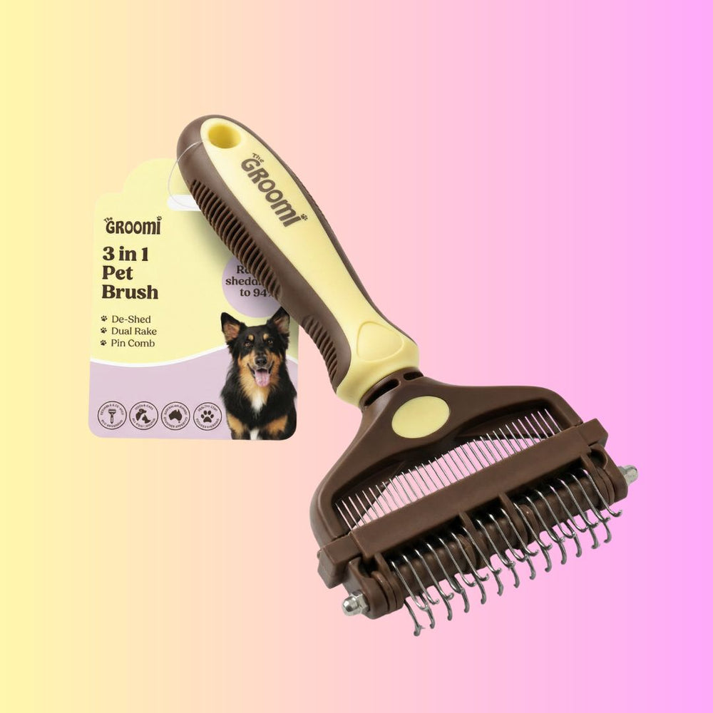 The GROOMI 3-In-1 Pet Brush, a manual dog and cat grooming brush with de-shed, dual rake and pin comb heads. It removes loose undercoat, detangles and cuts shedding on short, long, double and curly coats. Quiet, no vacuum needed, and gentle for nervous pets.